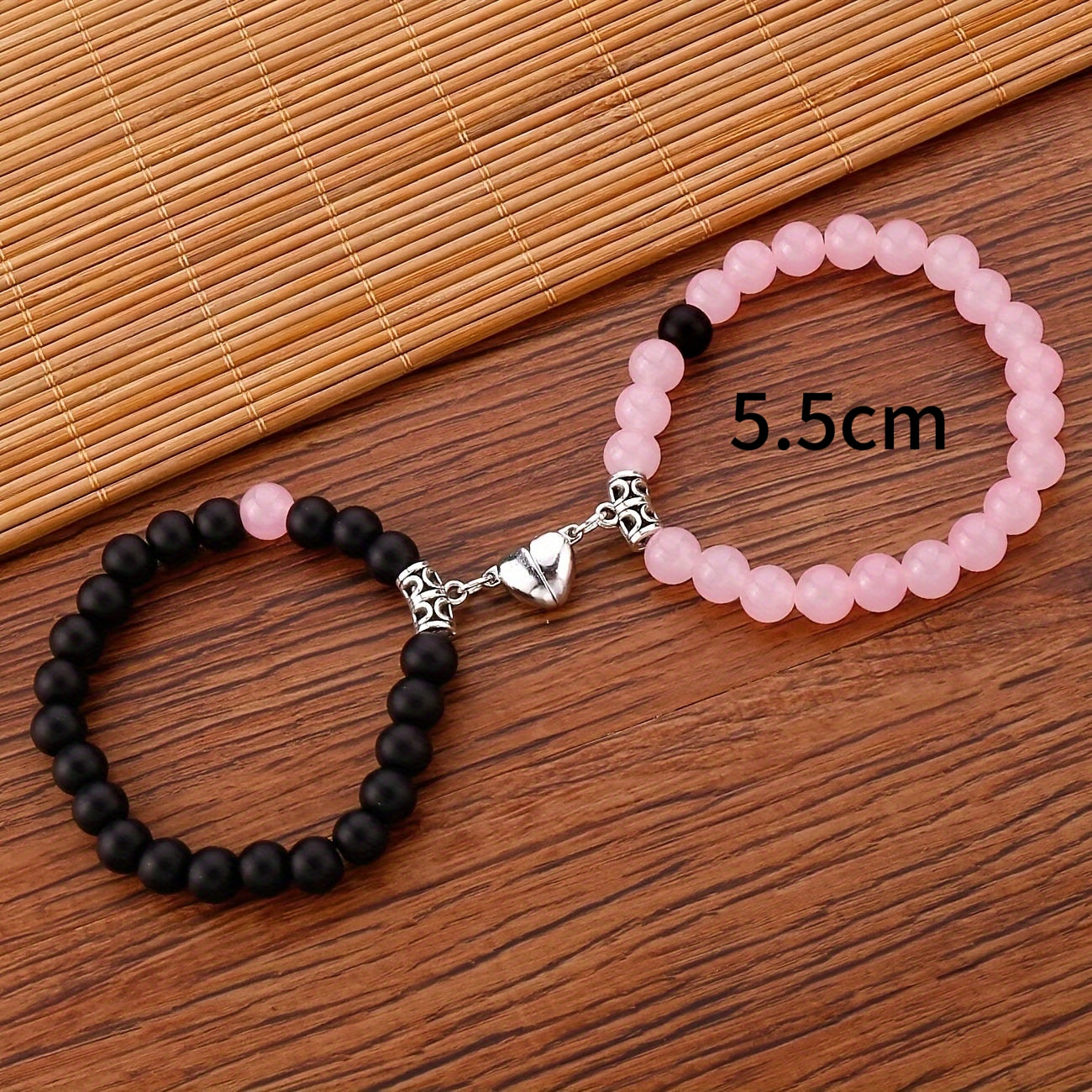 A Pair Of Pink And Black Beaded Bracelets, Perfect For Couples' Daily Wear Or As A Gift For Friends.