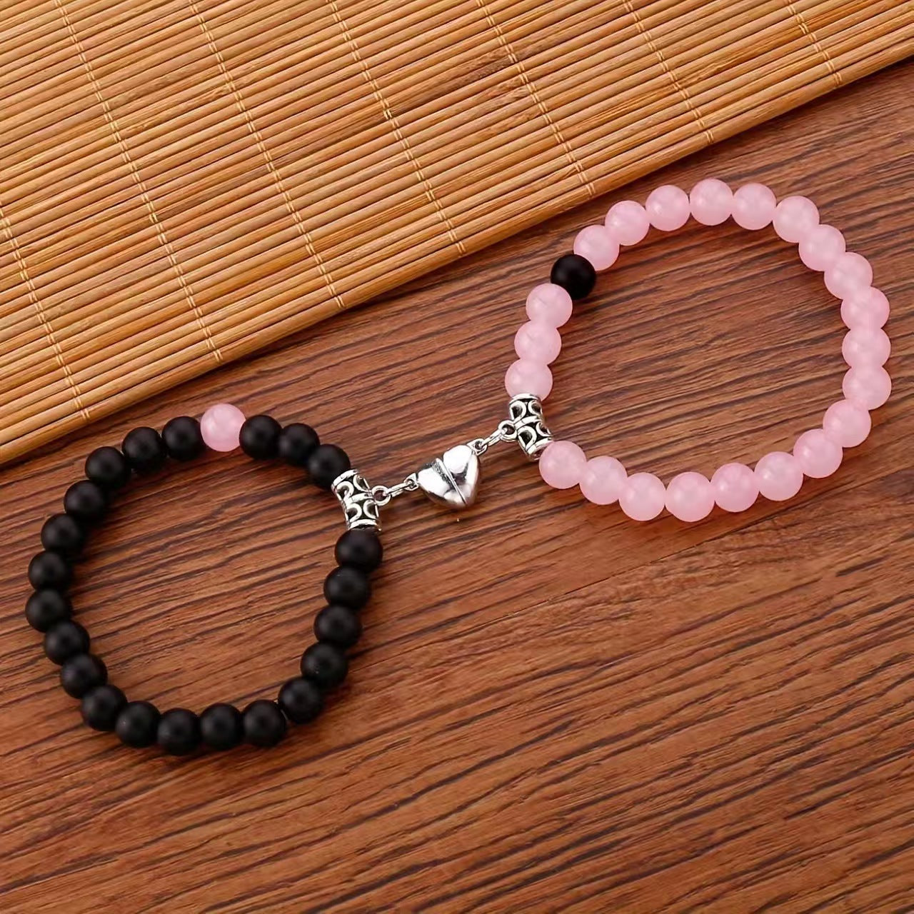 A Pair Of Pink And Black Beaded Bracelets